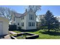 Charming exterior view of a two-story home with green shutters and well-maintained landscaping at 8200 E Desoto St, Muncie, IN 47303