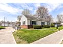 Inviting one-story home featuring a well-kept lawn, brick accents, and an accessible ramp at 830 N 16Th St, Elwood, IN 46036