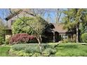Beautiful home showcasing stone accents, mature landscaping, and a well-manicured lawn at 889 Cedar Wood Pl, Carmel, IN 46032