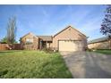 Beautiful one-story home with a two-car garage and well-manicured front yard at 8911 Country Walk Ct, Indianapolis, IN 46227