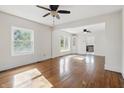 Spacious living room featuring hardwood floors and lots of natural light from the windows at 911 W Washington Ave, Shelbyville, IN 46176