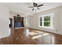 Sunlit living room boasts hardwood floors, a bay window, and a cozy fireplace at 911 W Washington Ave, Shelbyville, IN 46176