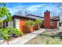 Charming brick home with well-maintained landscaping, pathway, and an attached garage at 9309 Golden Woods Dr, Indianapolis, IN 46268