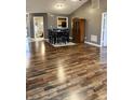 Open concept dining area featuring modern hardwood floors and a large wooden cabinet at 9671 Trail Dr, Avon, IN 46123