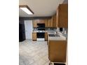Well-lit kitchen featuring modern appliances, and laminate countertops with oak cabinets at 9671 Trail Dr, Avon, IN 46123