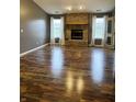 Spacious living room featuring hard wood floors and brick fireplace with abundant natural light at 9671 Trail Dr, Avon, IN 46123