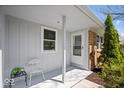 Welcoming front porch with a small seating area, offering a cozy spot to relax and enjoy the outdoors at 9814 E 17Th St, Indianapolis, IN 46229