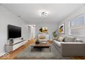 Bright living room featuring hardwood floors, modern decor, and a comfortable seating arrangement at 9814 E 17Th St, Indianapolis, IN 46229
