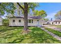 Inviting home showcasing a lush lawn and mature trees, creating a serene and picturesque setting at 102 Florence Dr, Greenwood, IN 46143