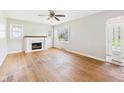 Bright living room featuring hardwood floors, a fireplace, and an abundance of natural light at 1327 Lindberg Rd, Anderson, IN 46012