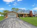 Well-maintained brick ranch-style home with attached garage and driveway at 1331 Dunlap Ave, Indianapolis, IN 46241