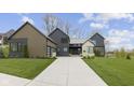 Beautiful exterior of this two-story home with concrete driveway, manicured lawn, and modern design at 1333 Chatham Rdg Ct, Westfield, IN 46074