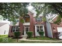 Inviting two-story home with a brick facade, complemented by a well-maintained lawn and lush landscaping at 13717 Van Buren Pl, Fishers, IN 46038