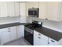 Modern kitchen featuring stainless steel appliances, gray countertops, and bright white cabinets at 1378 Hannibal St, Noblesville, IN 46060