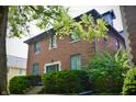 Brick home featuring beautiful landscaping and a tranquil outdoor space that offers a serene and inviting retreat at 1404 Broadway St # Apt G, Indianapolis, IN 46202