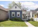 Inviting home with a blue exterior, well-kept lawn, and a paved walkway leading to the entrance at 1429 Fletcher Ave, Indianapolis, IN 46203