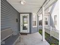 Welcoming front porch with a bench and a view of the charming neighborhood at 1429 Fletcher Ave, Indianapolis, IN 46203