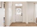 Bright foyer with wood floors, a white front door with a wreath, and views into other rooms at 15655 Woodford Dr, Westfield, IN 46074