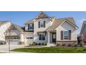 Charming two-story home with a manicured lawn, two-car garage, and beautiful architectural details at 15655 Woodford Dr, Westfield, IN 46074