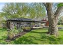 Landscaped home featuring an expansive yard, dark exterior, and manicured flower beds at 165 N 9Th St, Zionsville, IN 46077