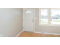 Bright entryway featuring a white door, trim, light gray walls and hardwood floors at 166 N Post Rd, Indianapolis, IN 46219