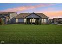 Spacious backyard featuring lush green grass, a covered patio, and mature trees for added privacy at 1973 Mobley Dr, Westfield, IN 46074