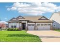 Charming one-story home with a well-manicured lawn, attached two-car garage, and neutral color scheme at 1973 Mobley Dr, Westfield, IN 46074