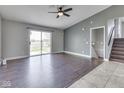 Living room boasts hardwood floors, ceiling fan and sliding glass doors at 212 Westridge Blvd, Greenwood, IN 46142