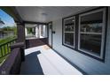 Covered front porch with a gray painted floor, brick detail, and view of neighborhood at 241 S Rural St, Indianapolis, IN 46201