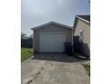 Detached garage with white door and concrete driveway at 2448 Winfield Ave, Indianapolis, IN 46222