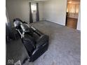 Empty living room with gray carpet and neutral paint, allowing for versatile design options at 2448 Winfield Ave, Indianapolis, IN 46222