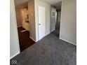 Open-concept space with neutral walls and carpet, seamlessly connecting living area to the kitchen at 2448 Winfield Ave, Indianapolis, IN 46222