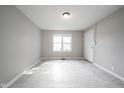 A bright living room with neutral colors and natural light, featuring laminate floors at 270 S Lasalle St, Indianapolis, IN 46201