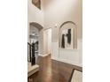 Open-concept foyer with archways, hardwood floors, and stylish wall decor at 2785 W High Grove Cir, Zionsville, IN 46077