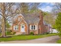 An attractive brick home exhibits traditional architecture and a neatly kept yard at 3221 Washington St, Columbus, IN 47203