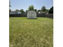 Spacious, flat backyard with a wooden shed and a fully fenced perimeter at 326 Virginia St, Fortville, IN 46040