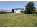 Large backyard featuring a sprawling lawn, mature trees, and partially fenced perimeter at 326 Virginia St, Fortville, IN 46040