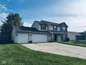 Spacious two-story home with a three-car garage and a large front yard at 326 Virginia St, Fortville, IN 46040