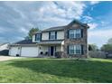 Beautiful two-story home with brick and siding exterior and a well-kept front lawn at 326 Virginia St, Fortville, IN 46040