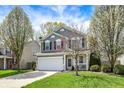 Charming two-story home featuring a well-maintained lawn, attached two-car garage, and inviting front porch at 3466 Firethorn Dr, Whitestown, IN 46075
