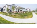 Beautifully landscaped yard, inviting front porch, and a well-maintained exterior create an inviting curb appeal at 360 Lincoln W Cir, Fortville, IN 46040
