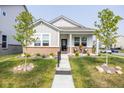 Inviting single-story home featuring manicured landscaping, a covered front porch, and a welcoming entrance at 360 Lincoln W Cir, Fortville, IN 46040