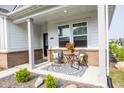 Cozy front porch with seating area, a decorative rug, and a charming view of the neighborhood at 360 Lincoln W Cir, Fortville, IN 46040