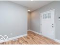 Bright entryway featuring a glass-paneled door and beautiful wood-look laminate flooring at 3758 Broadway St, Indianapolis, IN 46205
