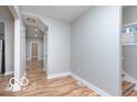 Inviting entryway with wood-look floors, light grey walls, and ample natural light at 3758 Broadway St, Indianapolis, IN 46205
