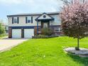 Inviting home exterior with a lush front lawn and mature tree, offering great curb appeal at 436 Tavistock Dr, Mooresville, IN 46158