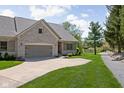 Beautiful brick home with well-maintained landscaping and a view of the surrounding greenery at 4557 Marigold Ct, Greenwood, IN 46143