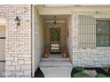 Inviting front porch with brick accents, stylish lighting, and decorative plants at 4557 Marigold Ct, Greenwood, IN 46143