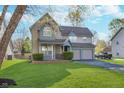 Charming two-story home with a well-manicured lawn and a two-car garage at 4917 Melbourne Rd, Indianapolis, IN 46228