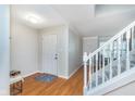 Inviting foyer features hardwood floors, staircase, and a neutral color palette at 4917 Melbourne Rd, Indianapolis, IN 46228